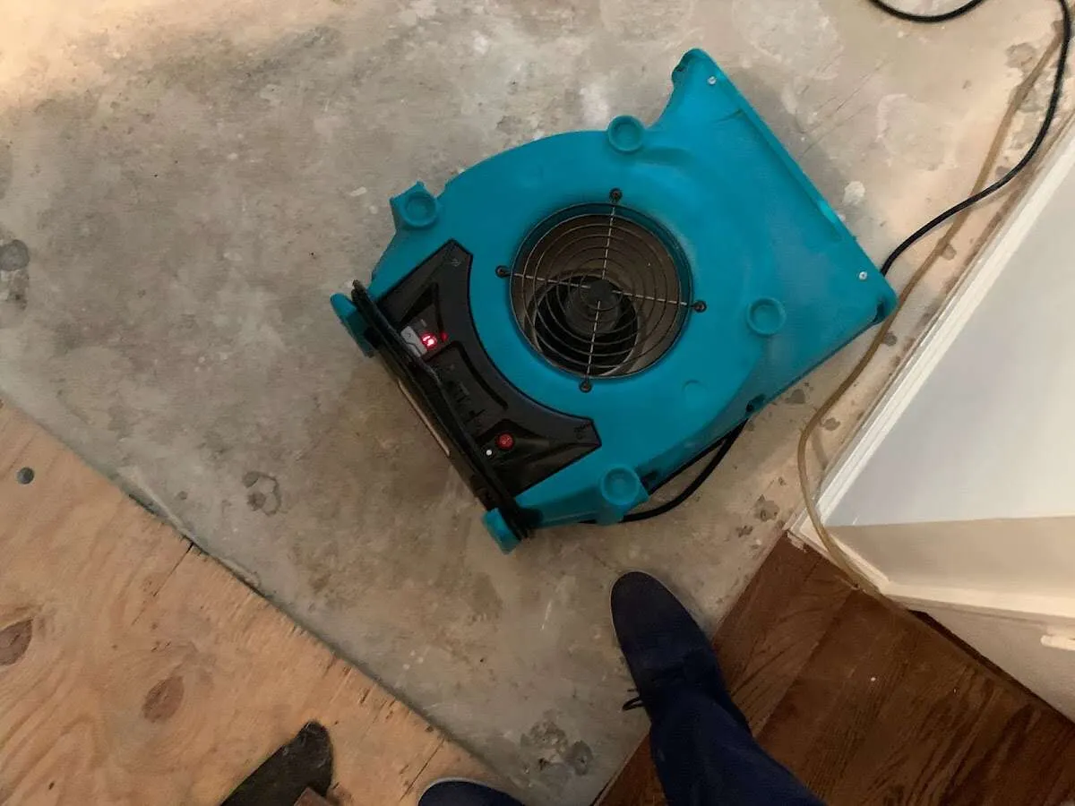 Air mover drying subfloor during Commercial Water Damage Restoration in Billings